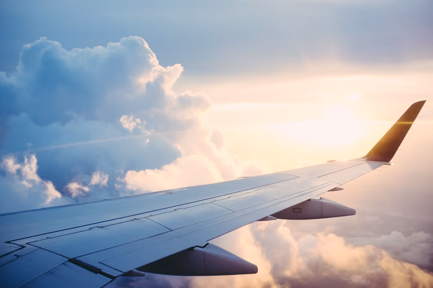 An aircraft wing at sunset — relocation and residence